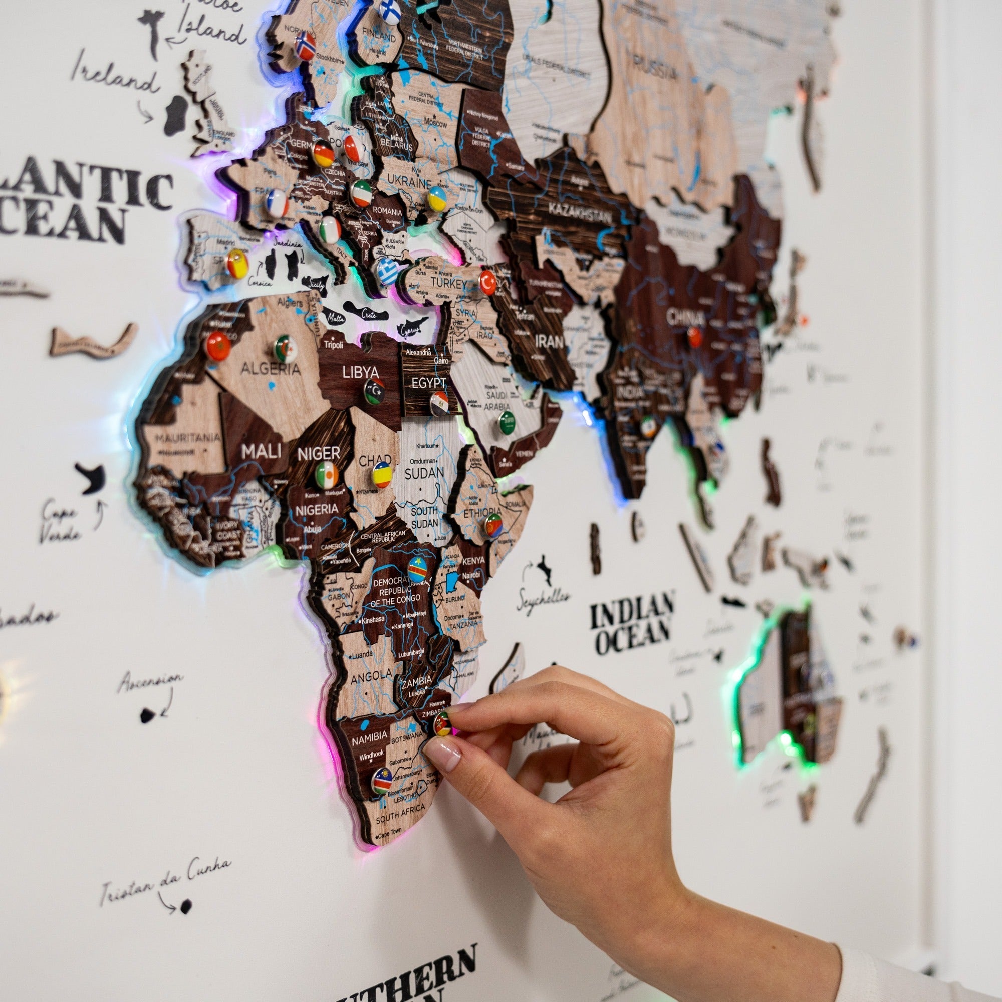 World map with LED lights and a hand interacting with it