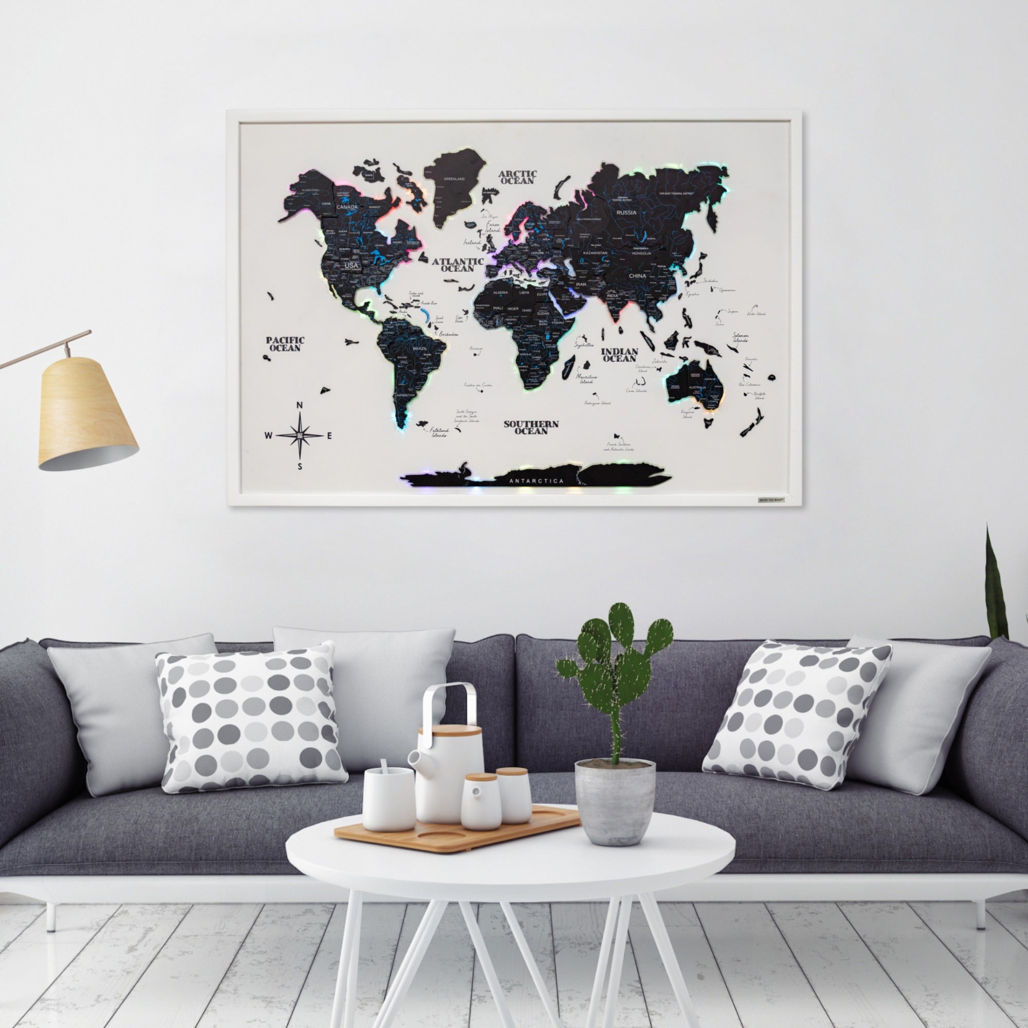 World map poster on a wall above a sofa in a living room