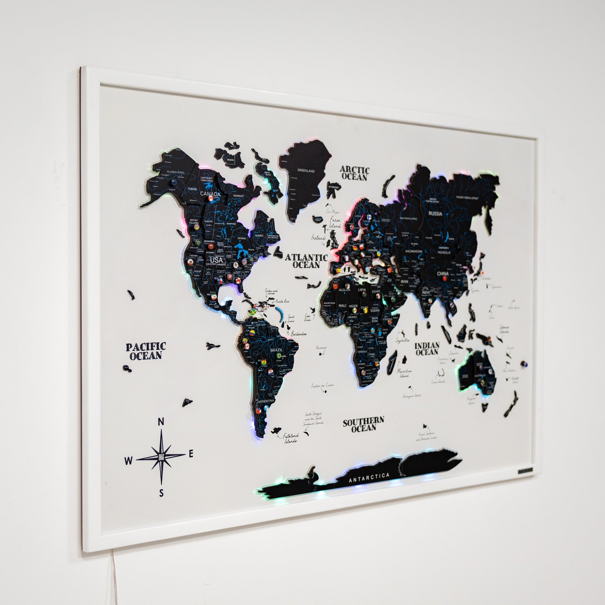 World map with pushpin holder on a white wall