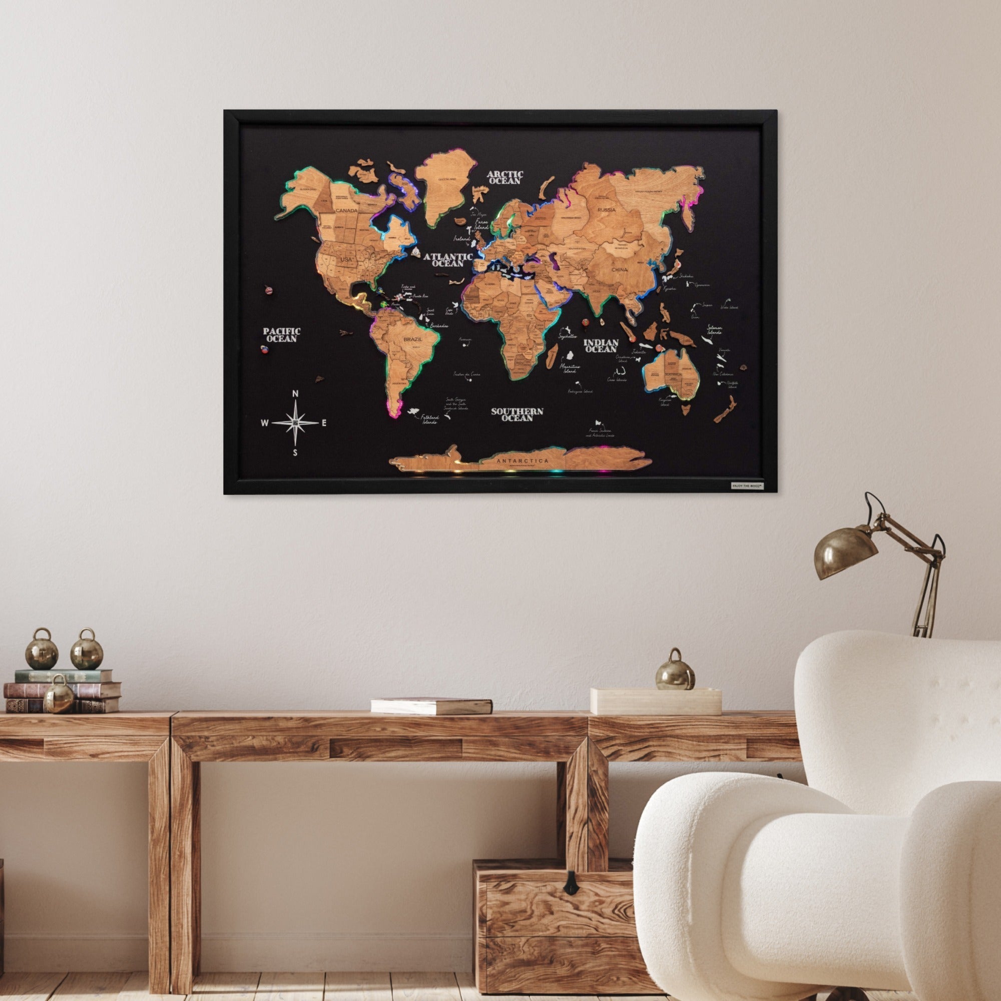 World map poster on a wall above a wooden desk with decorative items.