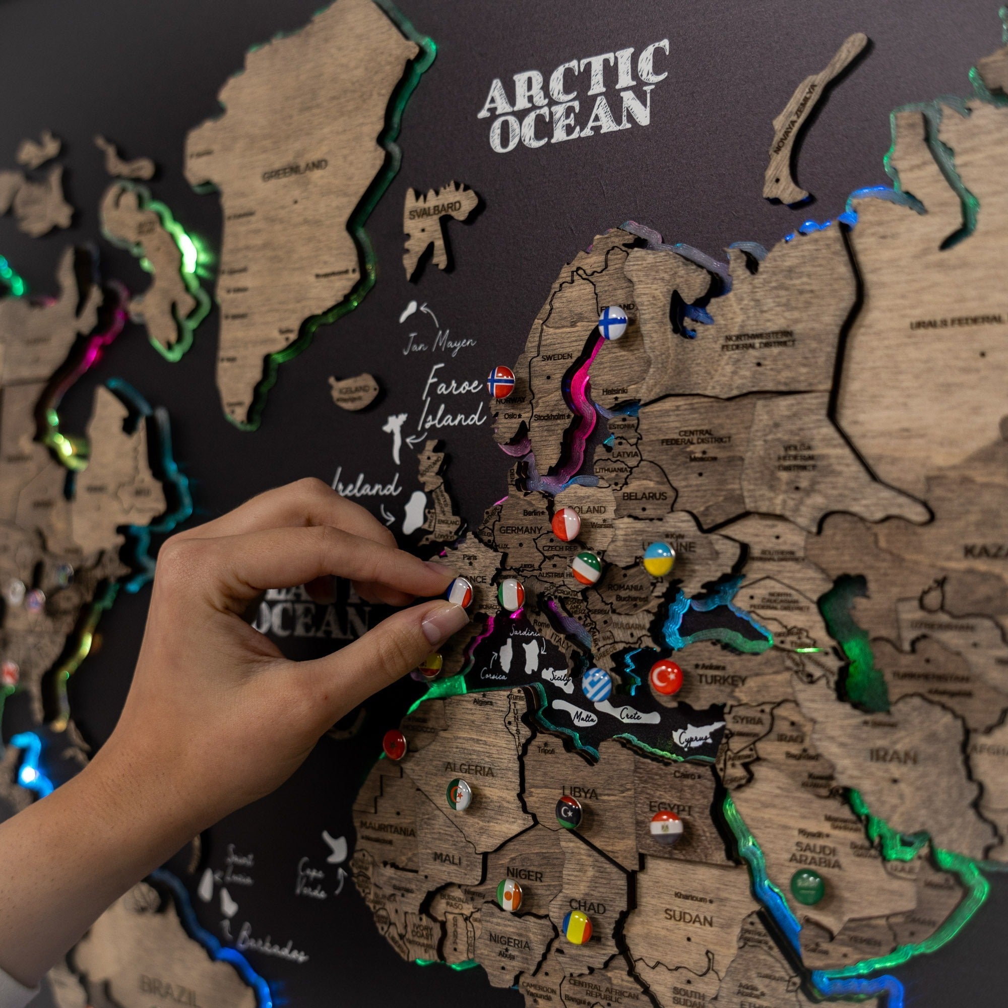 World map with countries labeled and a hand interacting with it