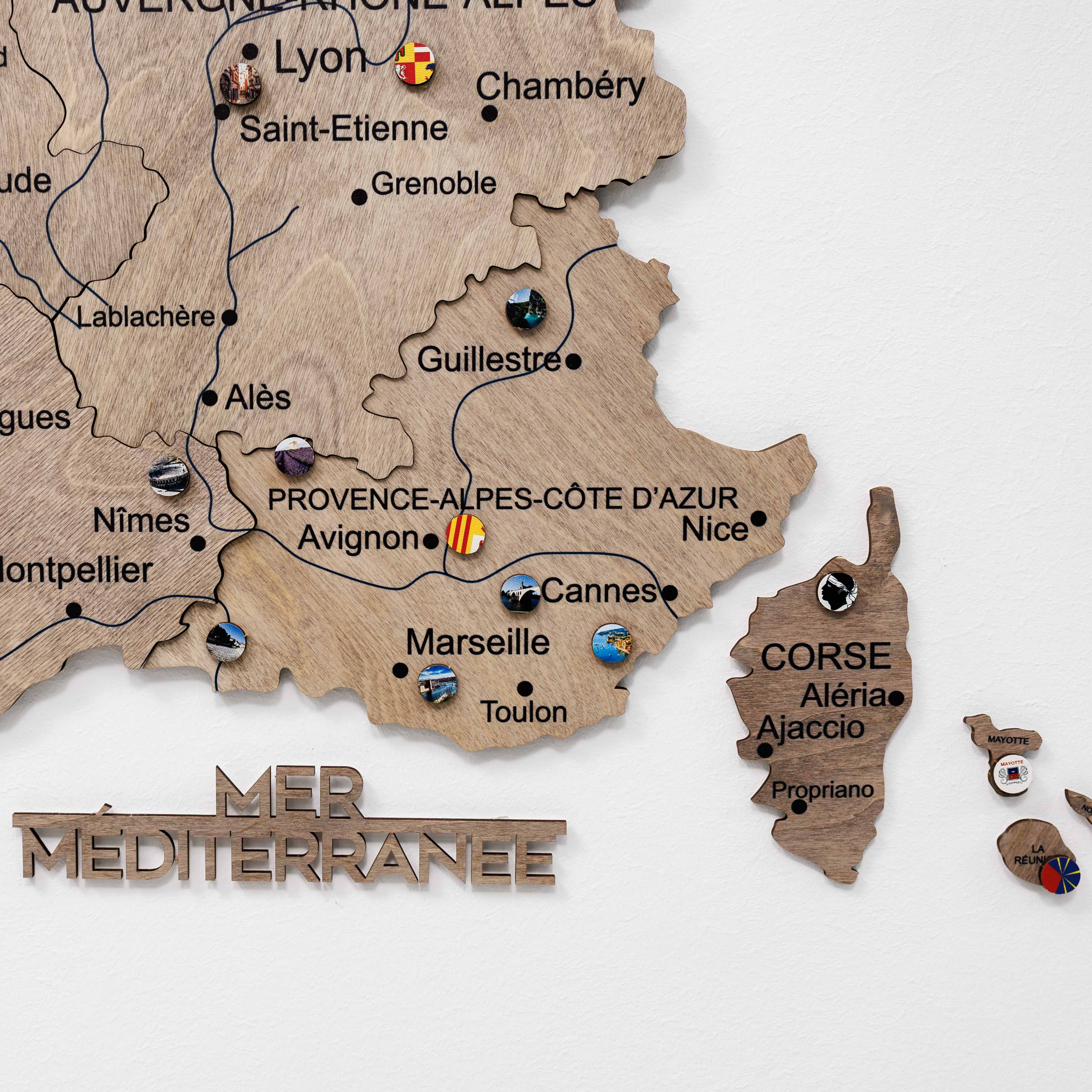 Wooden map of France with cities labeled on a white background