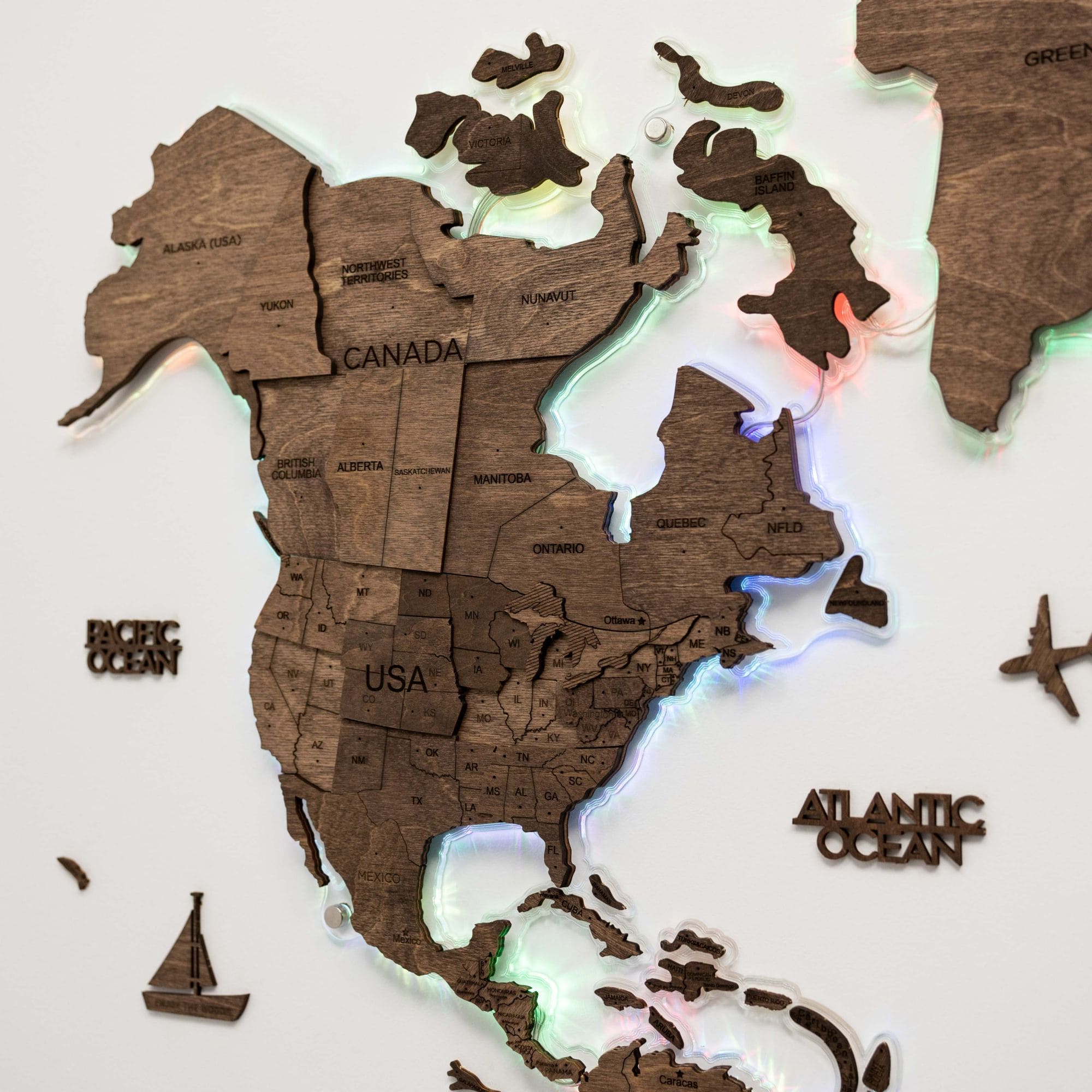 Wooden map of North America with glowing edges on a light background