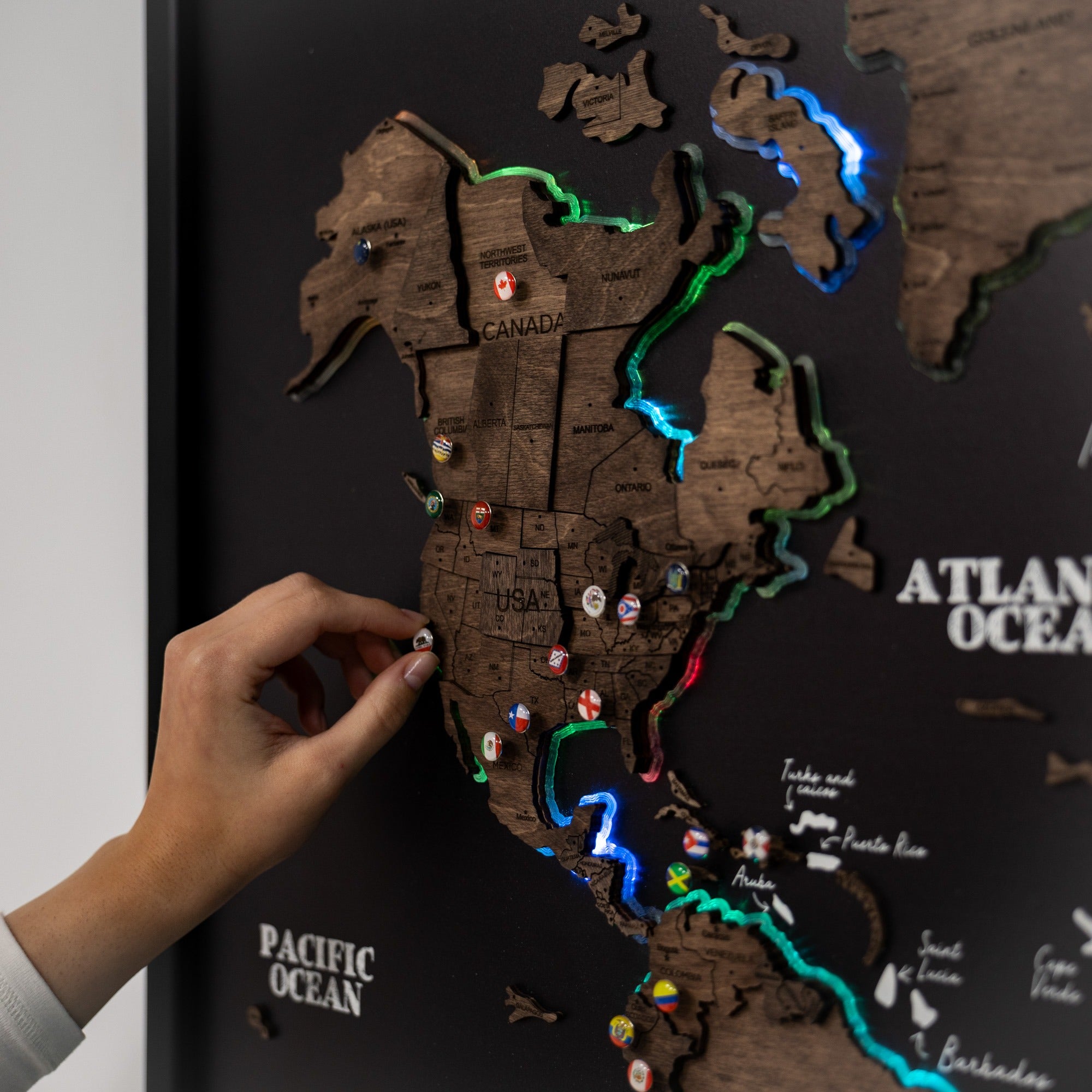 Wooden world map with pins on a dark background